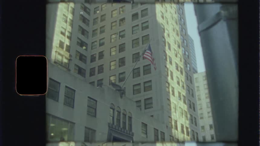 Flag flies on building lit by sunshine