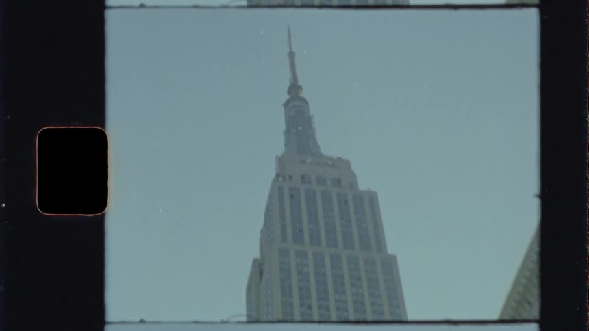 The empire state building and surrounding buildings from street level
