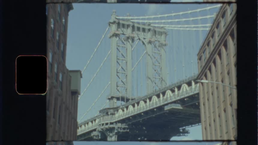 Cars travel over the bridge by the city