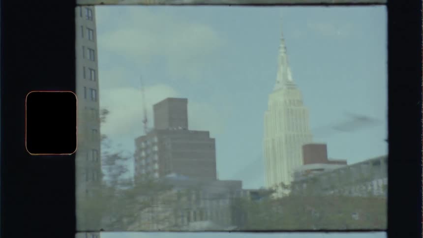 Shot of a city from inside of some unseen moving vehicle with large camera movements