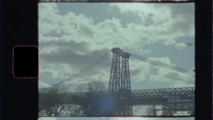 The vehicle is traveling towards the bridge