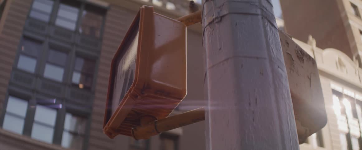 Walk signal changes to stop near low and mid rise buildings