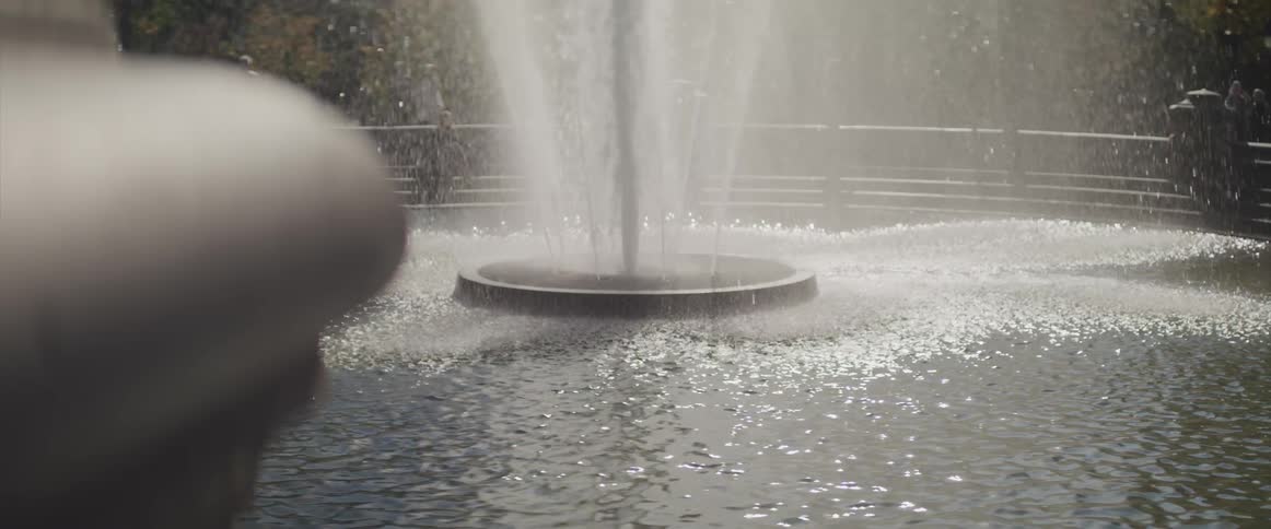 Large fountain with spraying up water in park