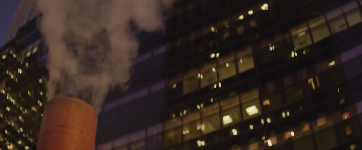 A smoke stack in front of a building