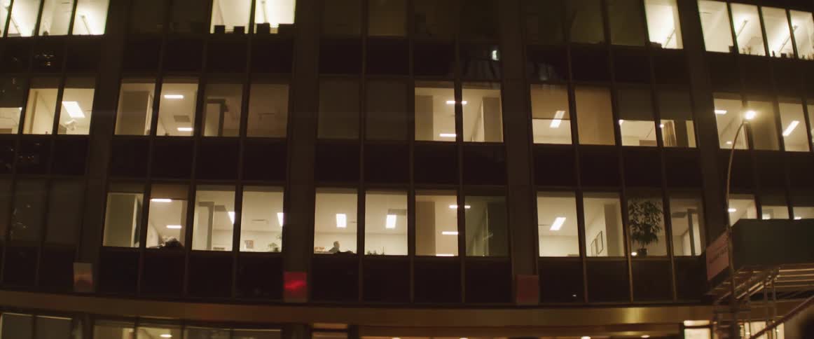 An office building is illuminated at night