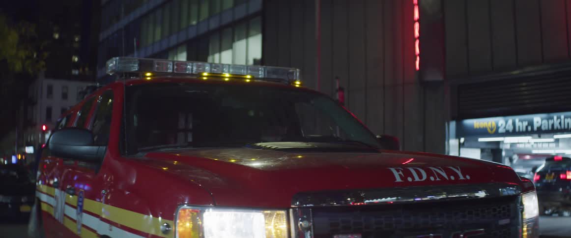 A man walks behind a fire department truck