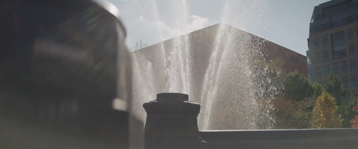 A water fountain in front of buildings