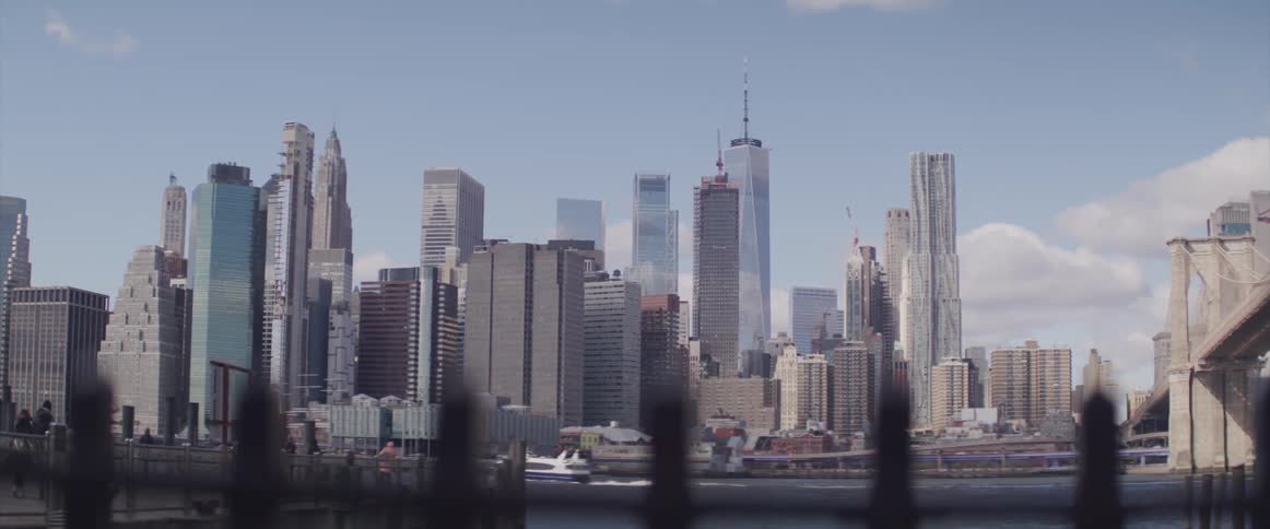A boat on the lake in front of a city skyline