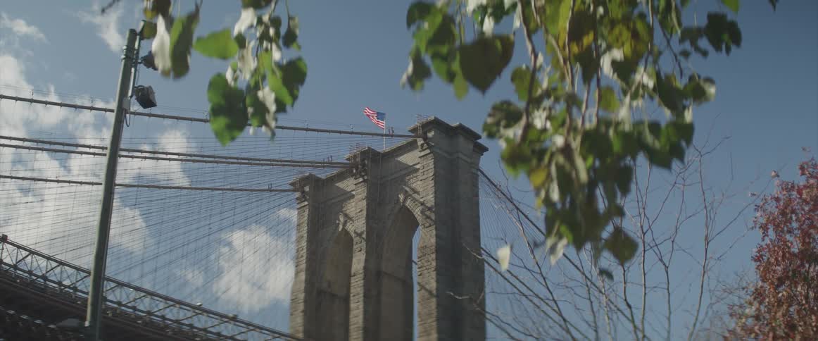 View of the brooklyn bridge tower and the american flag flying