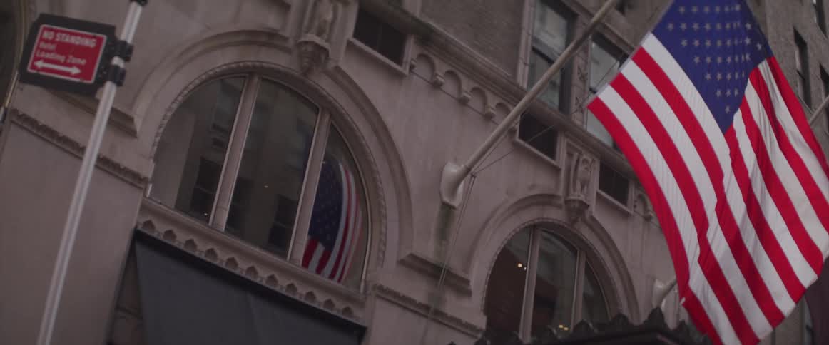 American flag waving on a building in city downtown