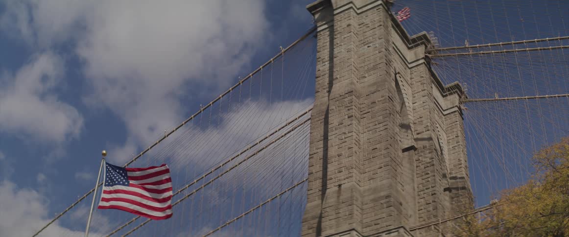 View of the brooklyn bridge tower and the american flag flying