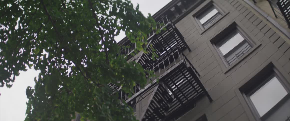 A fire escape of an apartment building on a cloudy day