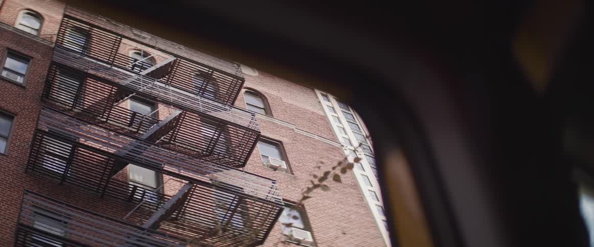 Balconies on a building from out of a car window