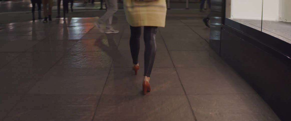 Pedestrians walking down a sidewalk