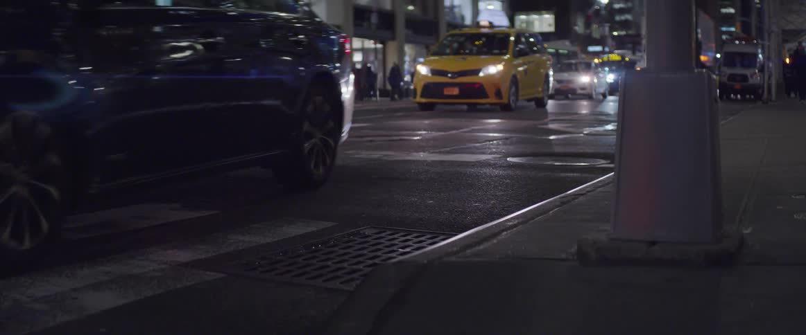 Traffic going through city street at night