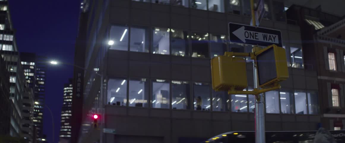 Focused shot on a walkdont walk pedestrian sign with city goingson going on around it