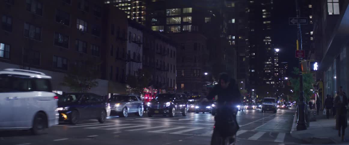 Traffic traveling a long a busy city street at night