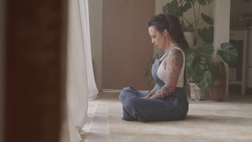 A woman sits and meditates