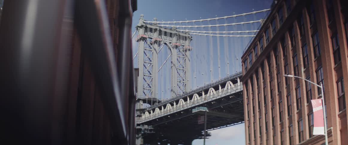 Time lapse of people walking below a bridge with cars driving on it