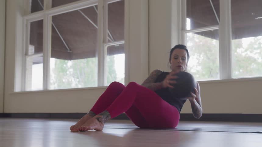 Tattooed woman works out at home