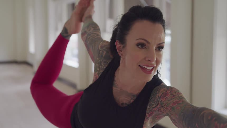 A woman holds a yoga pose