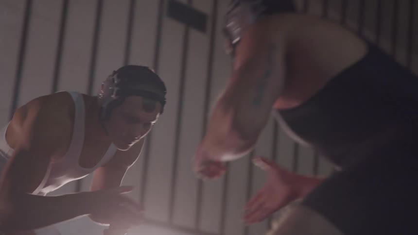Two men shake hands before a wrestling match