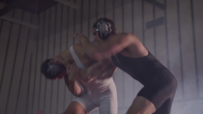 Two white men spar and wrestle