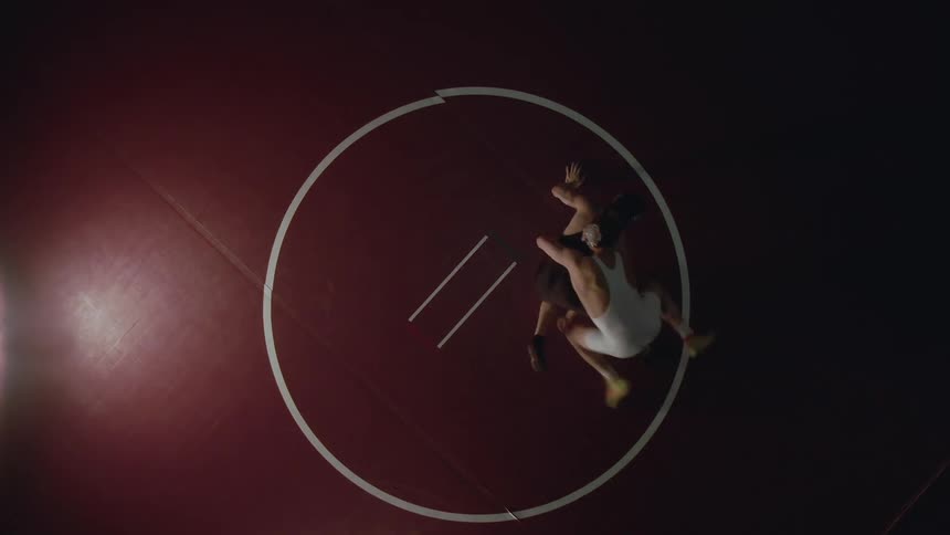Two people wrestle in the ring
