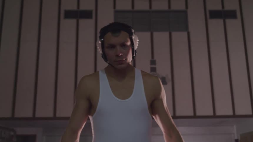 Young man in wrestling gear ready for a match in the gym