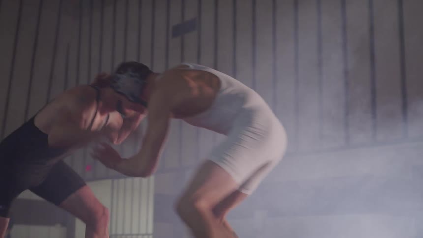 Two wrestlers battle it out in the ring