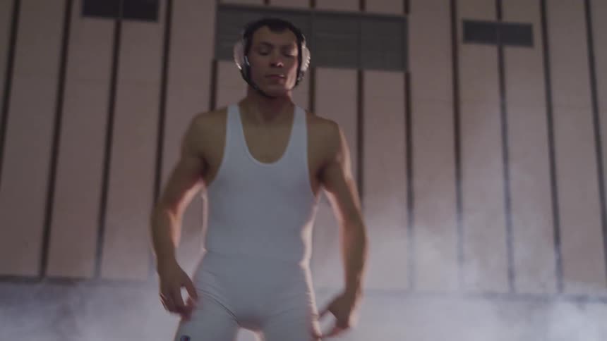 A teenager about to wrestle jumps to warm up