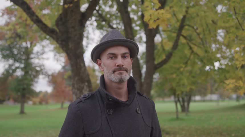 A man stands outside and looks in to the distance