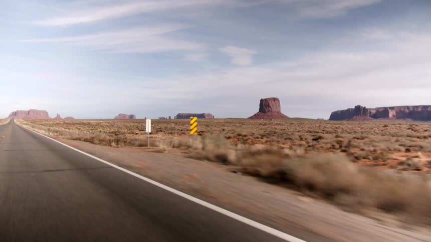 Traveling down a road with a large desert on the side