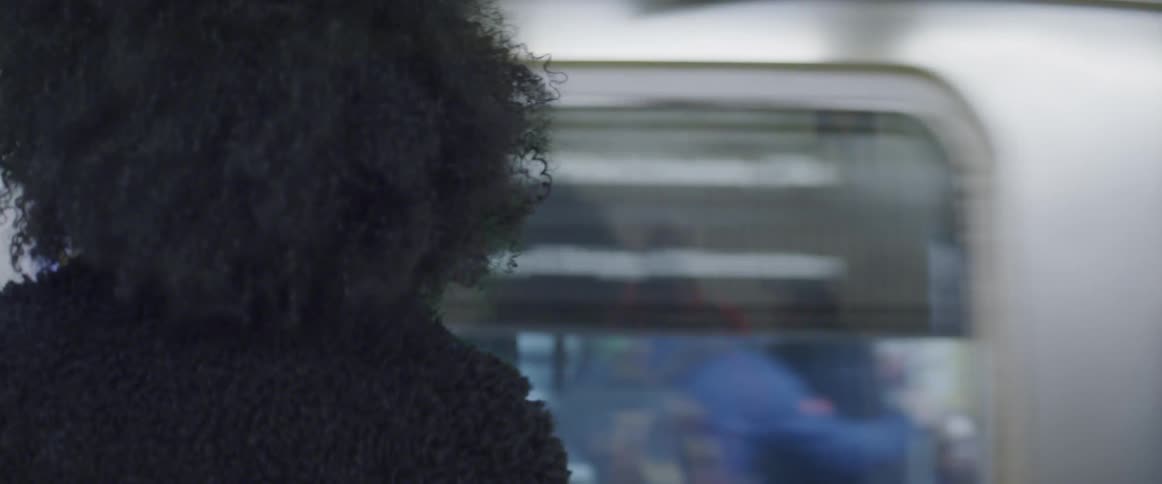 The woman stands waiting for the train