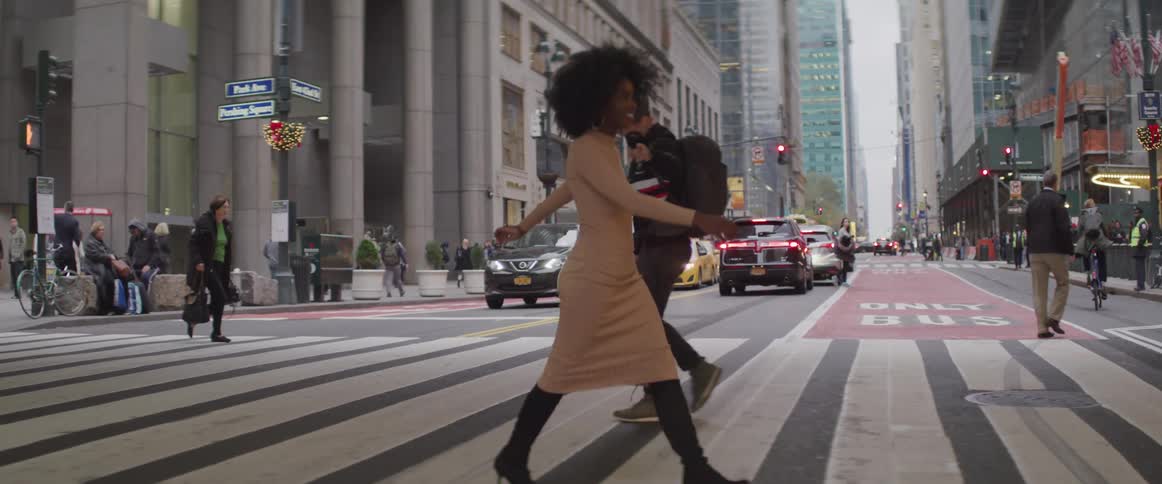 People cross the zebra crossing in the city
