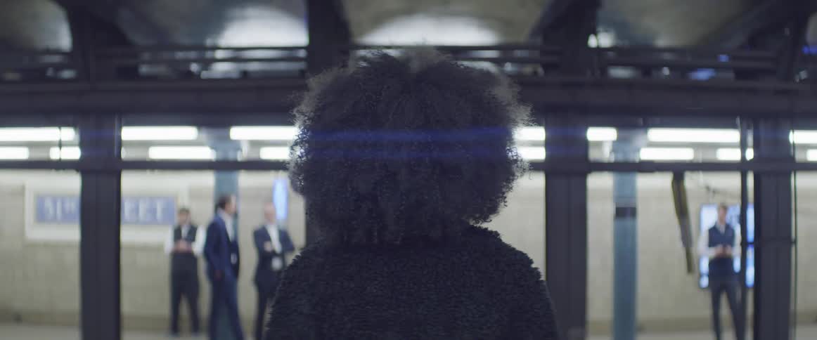 A woman faces a group of men in suits