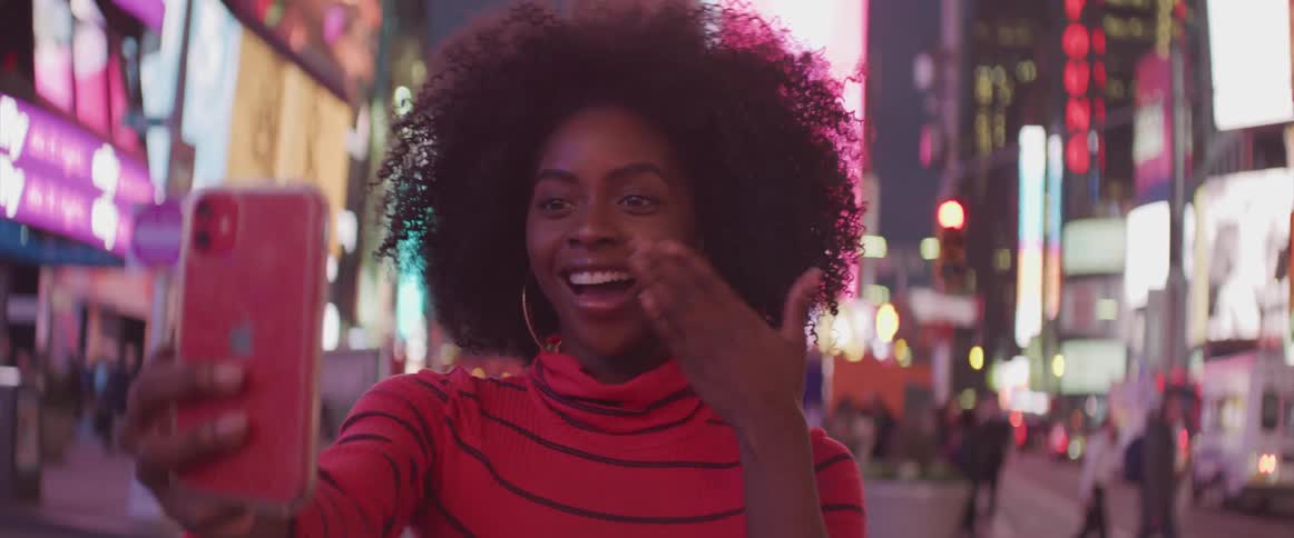 A woman takes a selfie in times square