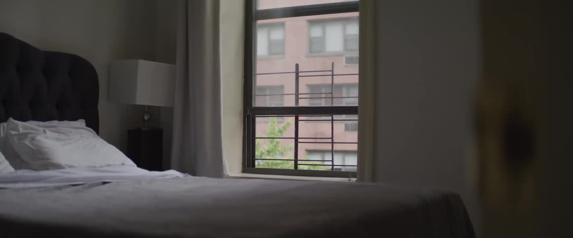 Bed near window in an empty bedroom on apartment