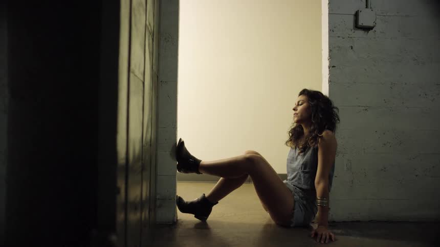 A teenager sits in a doorway