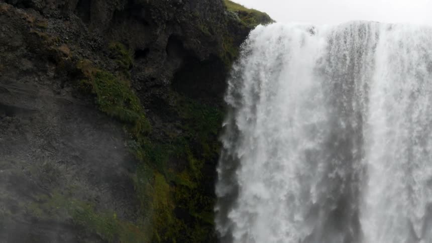 Water gushes over a cliff