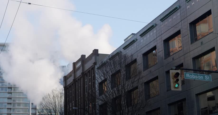 Steam rising up the streets in the city on a winter day