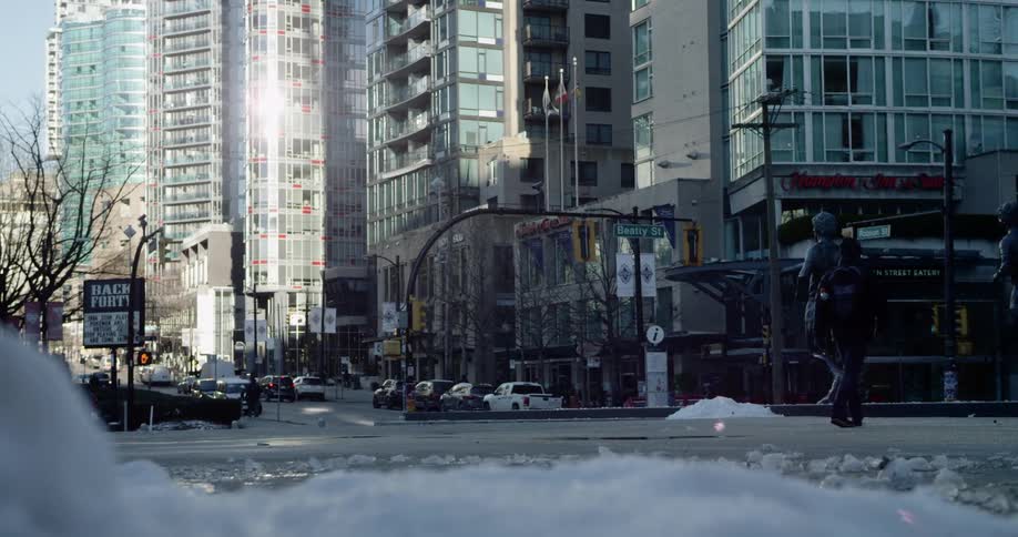 Snow piles on the streets of city downtown at morning