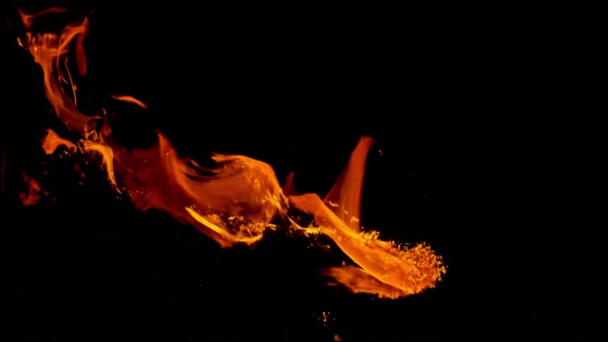 Flames burning against a dark background in slow motion