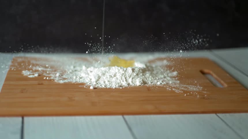 An egg crack on to some flour