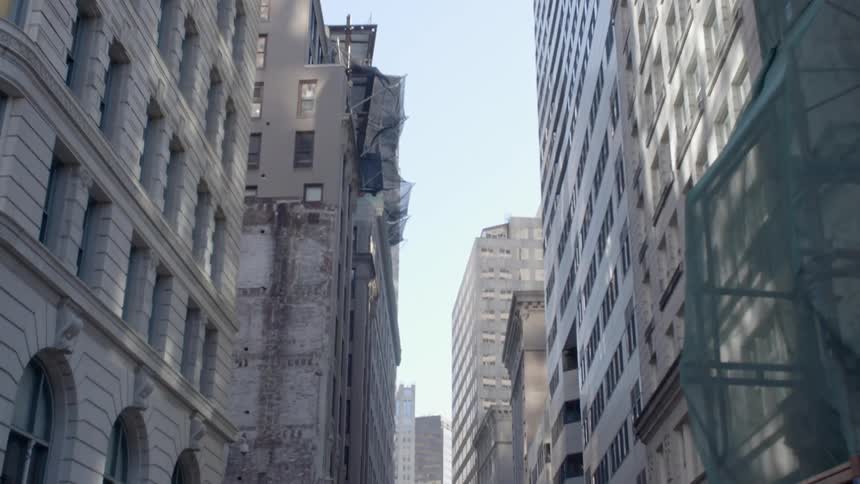 The tall buildings surround the small street