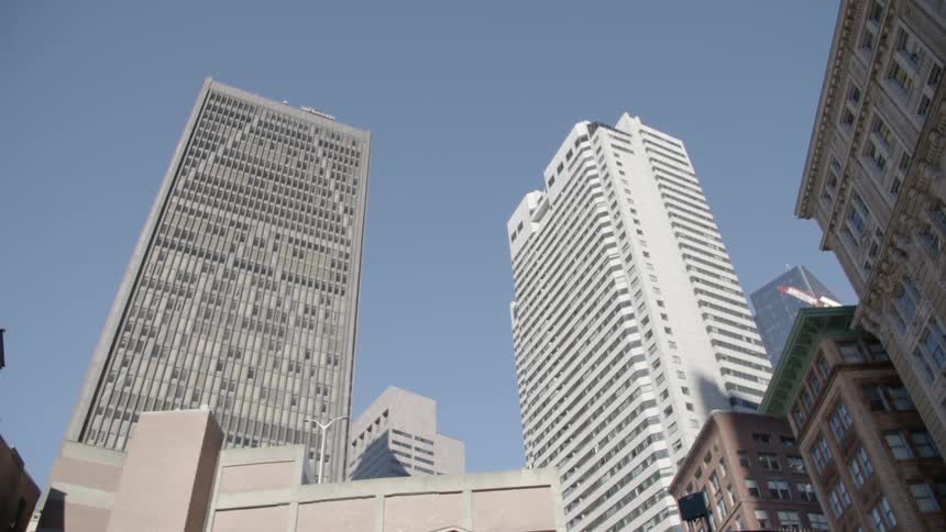 Skyscrapers tower over other buildings against clear blue sky