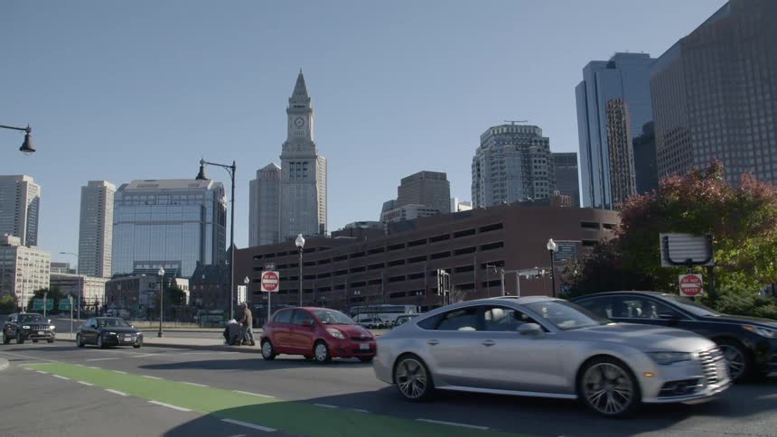 Vehicles travel an intersection by a large city
