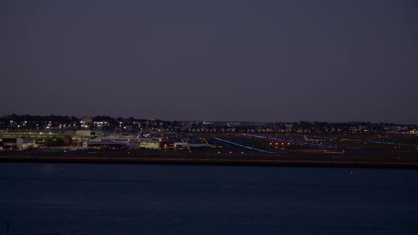 The twinkling lights of a city seen from off the coast