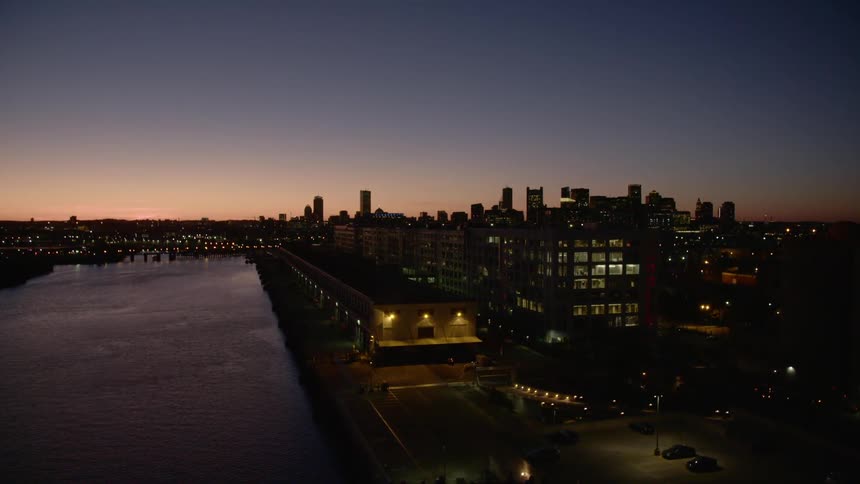 Aerial view of waterfront city skyline at sunset