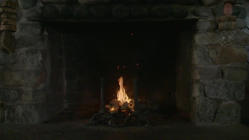 A fireplace with fire embers and smoke
